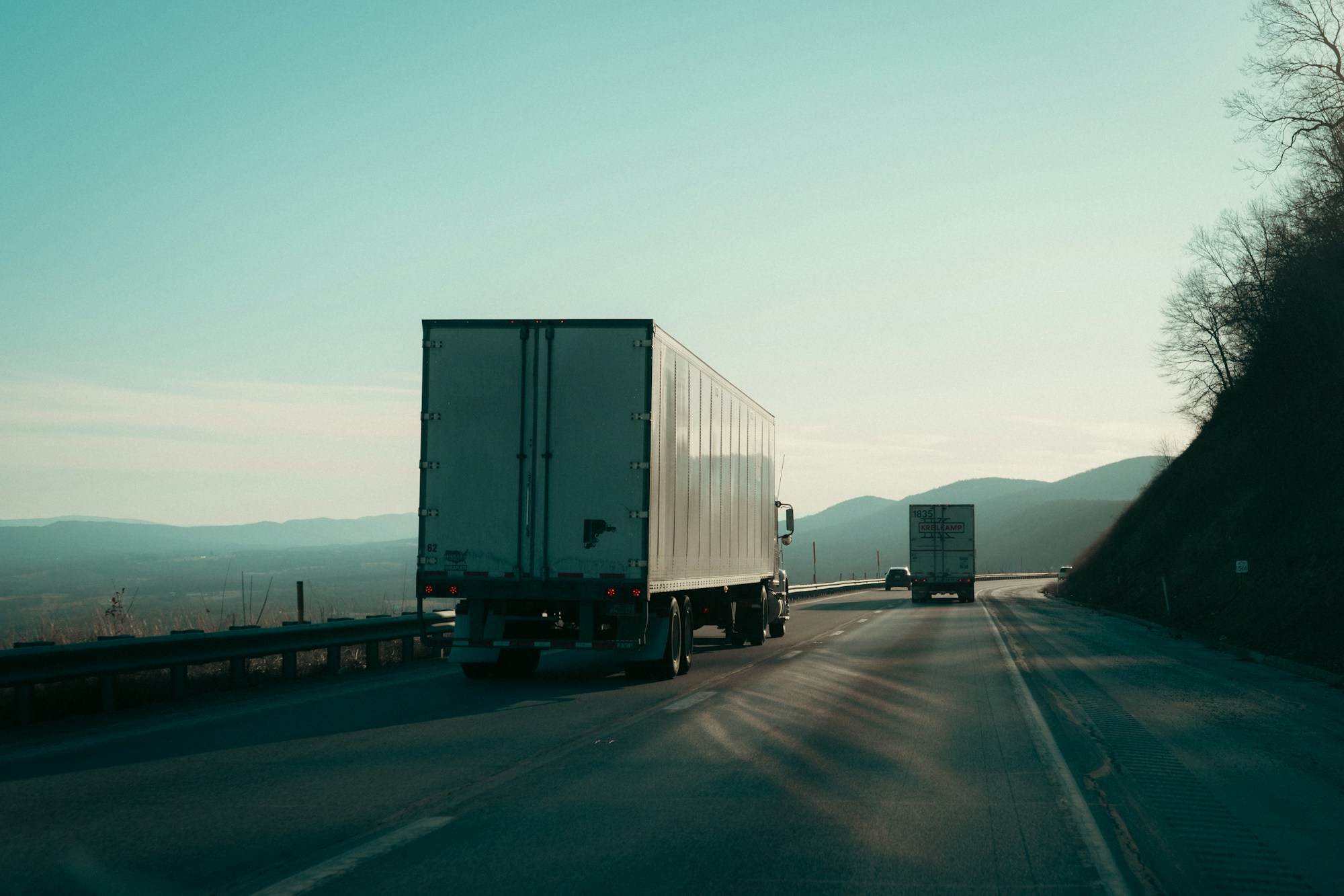 Freight trucks on a winding highway through Virginia mountains